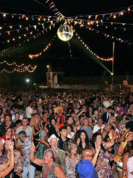 Bola de espejos y p�blico bailando en El Gran Guateque, ambiente festivo y retro